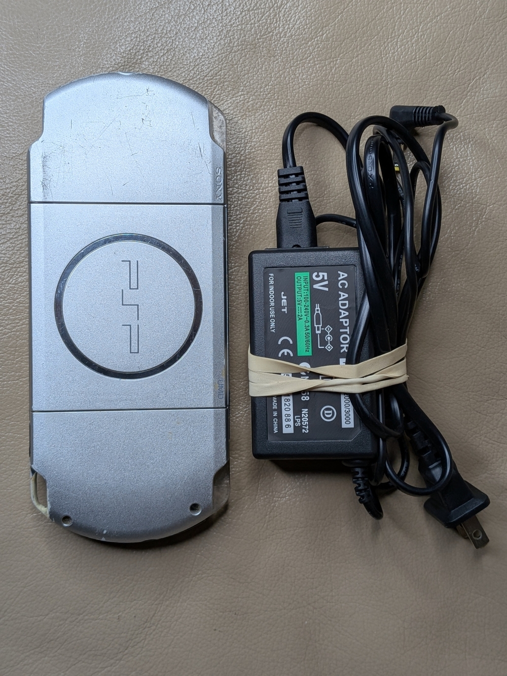 Sony PSP 3001 - Silver with new 5v Power Adapter. Works But Won't Read Games.